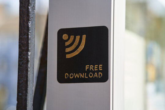 Free download hand written on on a black tag with gold paint. Wi-fi sign is visible. 