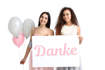 Beautiful young women holding paper with word DANKE (German for Thanks) and balloons on white background