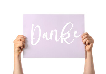 Fototapeta premium Male hands holding paper with word DANKE (German for Thanks) on white background