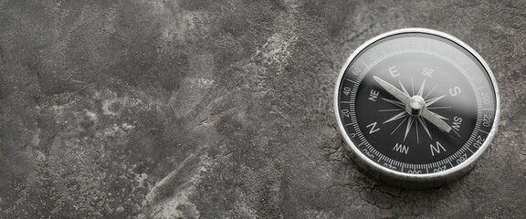 Compass on grey background with space for text
