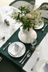 Stylish table setting for wedding celebration in dining room