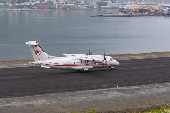 eagle air Dornier 328 turboprop airplane on the runway of Isafjordur airport