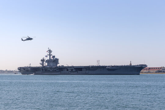 San Diego, California, USA - May 2, 2013: USS Carl Vinson (CVN-70) Nimitz-class nuclear-powered aircraft carrier operated by the United States Navy maneuvering in San Diego Bay near NAS North Island.