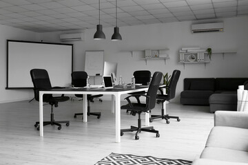 Interior of conference hall with big table and modern computers