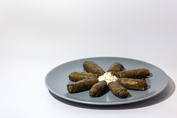 Traditional georgian dolma with sour cream on a plate