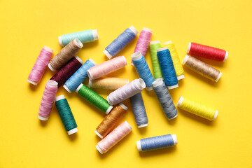 Thread spools on yellow background