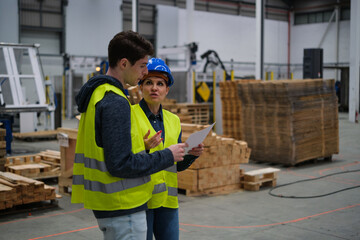 two young engineers working with robots