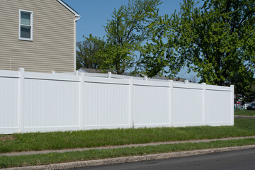 White vinyl fence in a cottage village fencing of private property