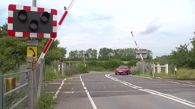 barriers lift to allow traffic through - automatic level crossing 4:2:2