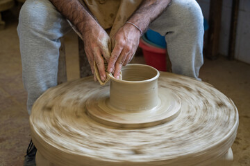 Potter shaping a piece of clay