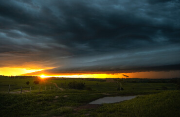 Sunset over the field, sunset storm clouds