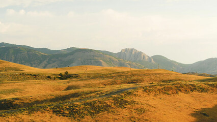 Obraz premium Top view of dry autumn meadows on the hills. Shot. Bright orange grass on a Sunny day