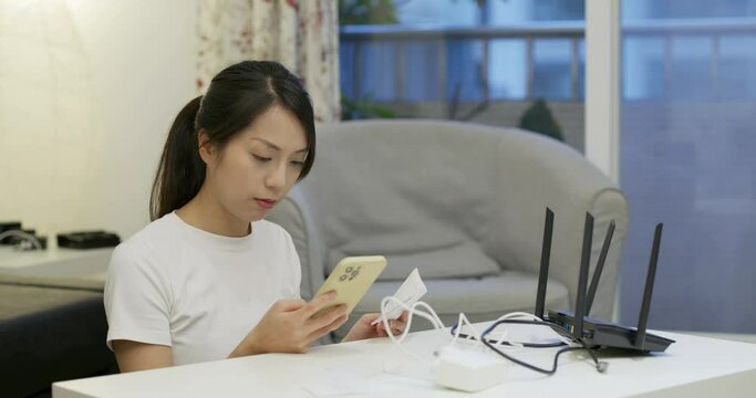 Woman study to connect the cable with router