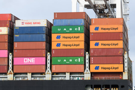 Seattle - April 03, 2022; Intermodal shipping containers stacked on a ship as a part of the global trade economy.