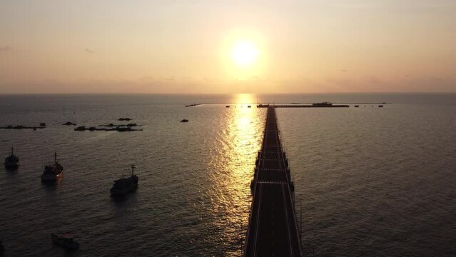 Aerial View of the Pier on the Ocean At Sunset, View of the Sun and the Ocean In the Evening
