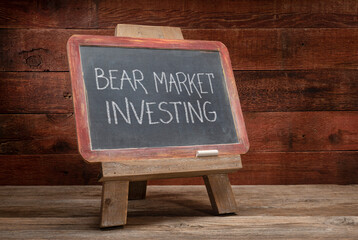 bear market investing - white chalk writing on a slate blackboard,  easel sign in a retro classroom, financial concept