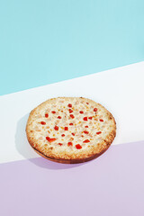 Italian pizza with chicken and paprika on coloured background. Cheese pizza with chicken and corn in minimal style on blue and purple color. American pizza delivery concept with color backdrop