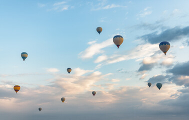 Awesome view of flying colorful hot air balloons at sunrise