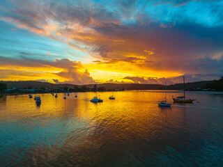 Aerial sunrise waterscape with boats, colour and clouds