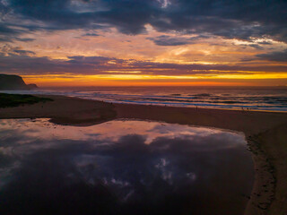 Dawn reflections and clouds at the seaside with lagoon