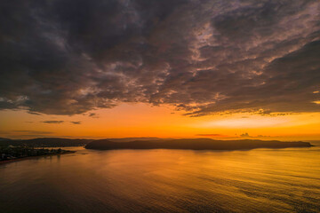 Fototapeta na wymiar Aerial sunrise seascape with low clouds