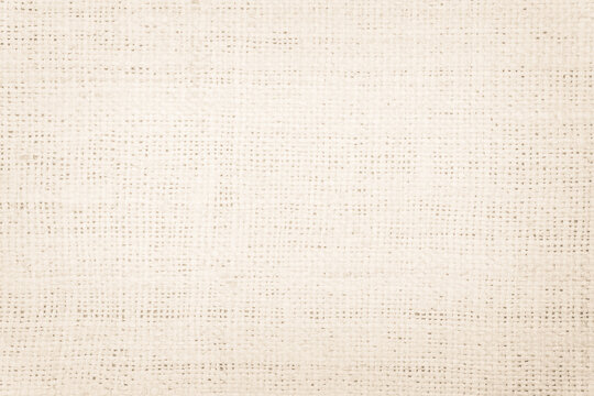 Jute hessian sackcloth burlap canvas woven texture background pattern in light beige cream brown color blank. 