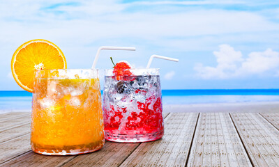 Orange juice in clear glass with ice cubes and Mocktail Strawberry Soda not mix alcohol. Fresh strawberries. Cold drinks placed on the wooden balcony by the sea In the middle of the day. 3D rendering