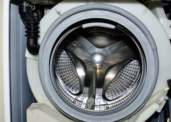 Open front load washing machine, ready to be serviced