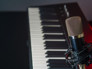 Recording studio. Synthesizer, midi keyboard and microphone. Minimalism. Singing, music, workplace of a musician, composer. Professional and home music studio.