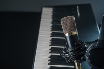 Professional and home recording studio. Synthesizer, midi keyboard and microphone. Minimalism. Singing, music, recording on radio, television. There are no people in the photo. Banner, advertising.