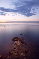 seashore with rocks at sunset