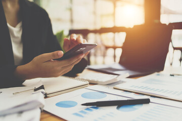Business process photo. Account manager using mobile phone. Typing contemporary smartphone screen. Horizontal.