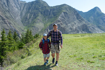 Fototapeta na wymiar Father and son hiking in the mountains