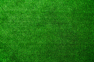 A background texture image of real green AstroTurf artificial grass. 