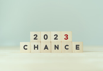 Chance concept for business or life in 2023. Wooden cubes 2023 with text "CHANCE" on beautiful grey background and copy space. Starting new chances, opportunities in new year.
