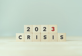 Crisis management concept in new year 2023 . Unexpected situation effects to business and life.  Wooden cubes 2023 with text "CRISIS" on beautiful grey background and copy space.