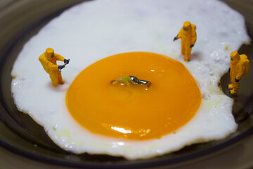 Researchers are examining a person who drowned in an egg yolk on a plate