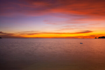 Landscape Long exposure of majestic clouds in the sky sunset or sunrise over sea with reflection in the tropical sea Beautiful seascape scenery Amazing light of nature sunset
