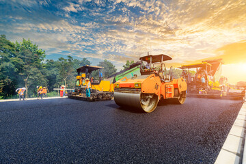 Construction site is laying new asphalt pavement, road construction workers and road construction...