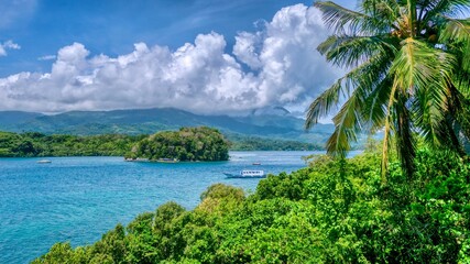 Wide angle view of Dalaruan Bay and the beautiful mountains and coastline of the popular seaside resort of Puerto Galera on Mindoro Island, Philippines.