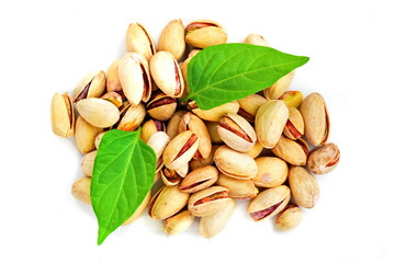 Bunch of ripe pistachio nuts with green leaves isolated on a white background. Top view