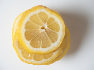 Close-up of a lemon cut into slices on a white background. isolated fruit. Sour yellow fruit full...