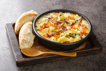 Potato spicy soup with crispy bacon close-up in a plate on the table. horizontal