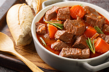 French beef stew in red wine known as daube de boeuf Provencal closeup in the wooden tray on the...