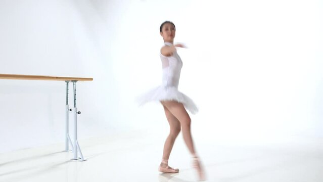 A young women dress in white to practice ballet
