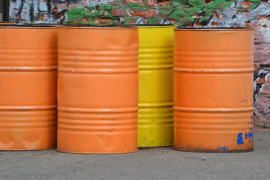 Yellow and orange painted iron barrels
