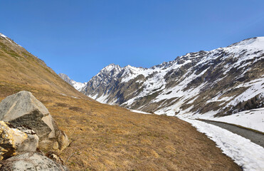 meadow and peak mountain  with snow and river at spring  in alpine landscape