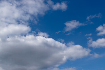 Fluffy white clouds on a blue sky background. Nature background