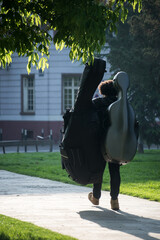 Mulhouse - France - 2 May 2022 - Portrait on back view of musician walking in a public garden © pixarno