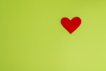 Concept of charity and healthcare donation. Heart symbol of love and romance on green background